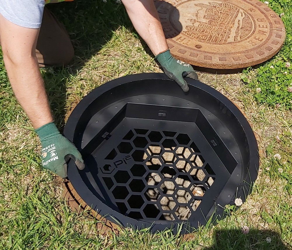 black webbed manhole cover